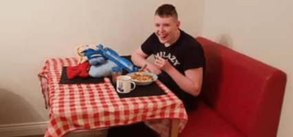 Freddie enjoying a meal with his new dining furniture