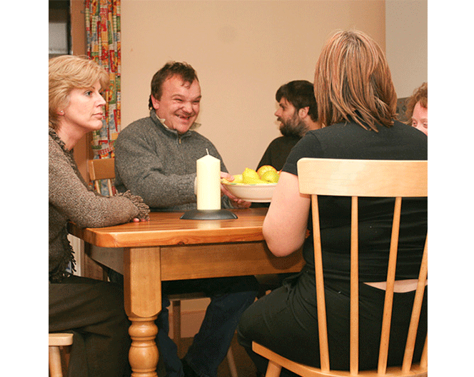 An image of people sat around a table