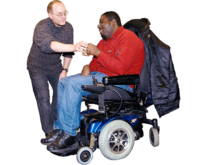 An image of a man in a wheelchair with another man